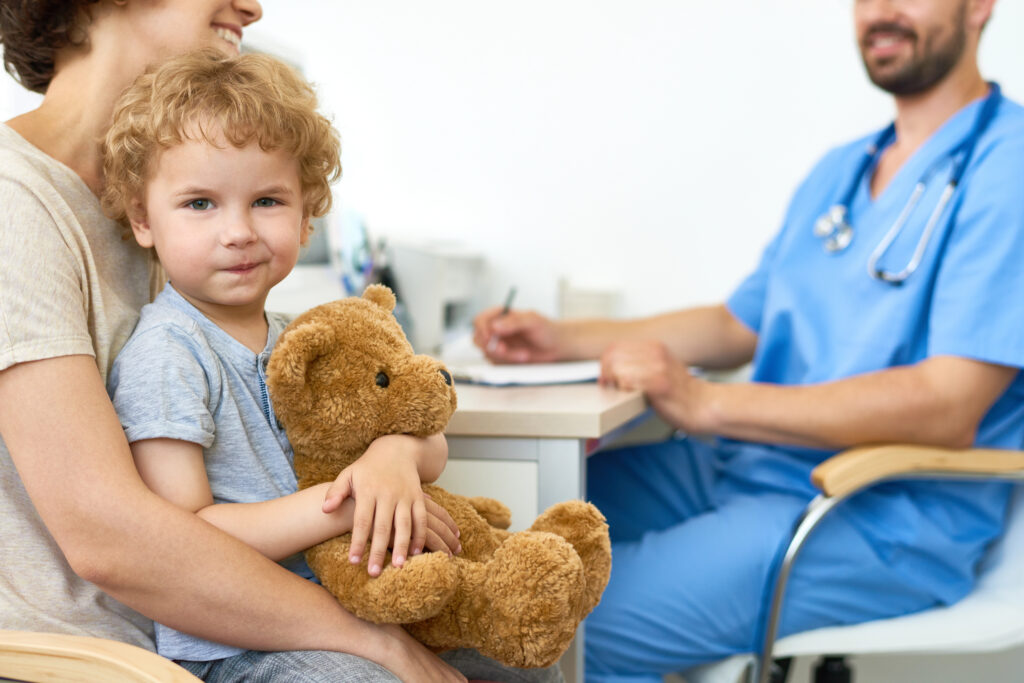 kid at doctor while mom asks questions
