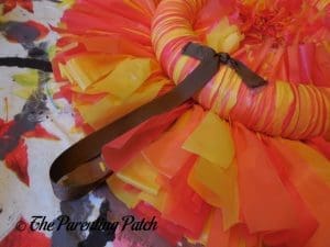 Tying a Yarn Hanger to the Tablecloth Ribbon Thanksgiving Wreath Craft