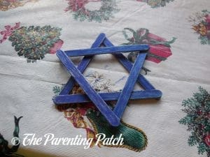 Coloring the Star Blue for the Star of David Hanukkah Ornament Craft