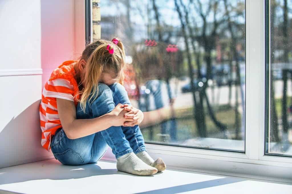 Little girl in orange blouse crying