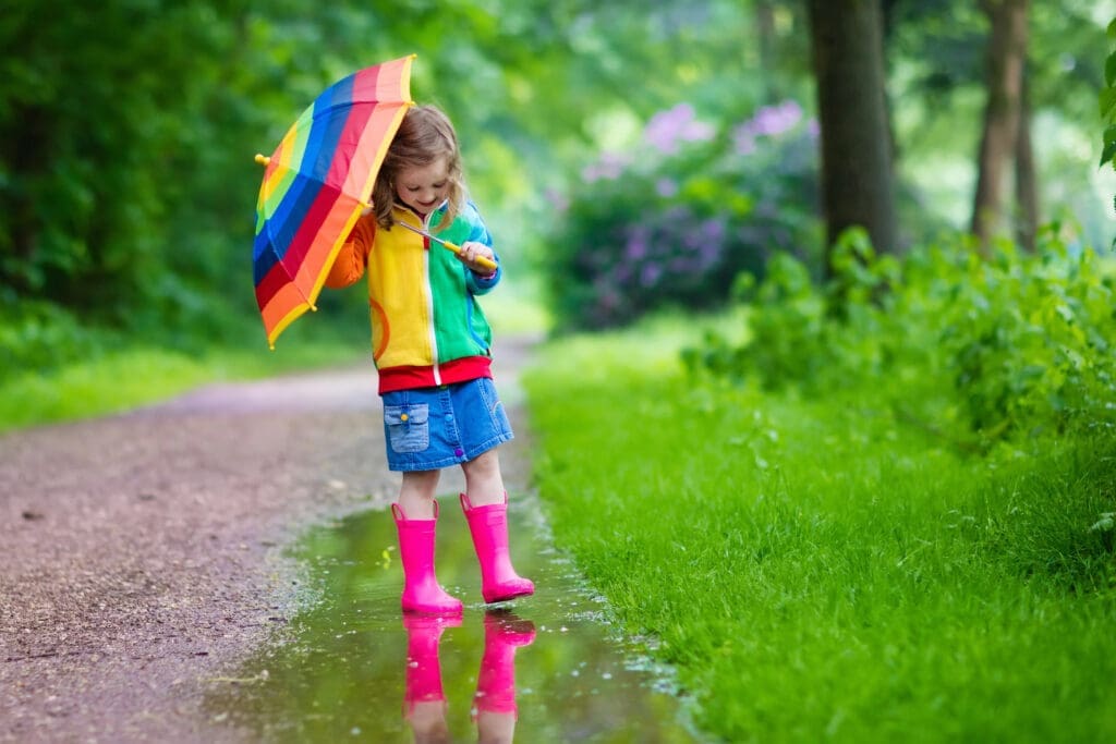 Child playing in the rain