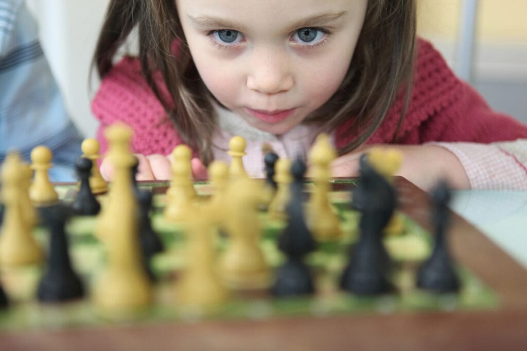 Little girl playing chess
