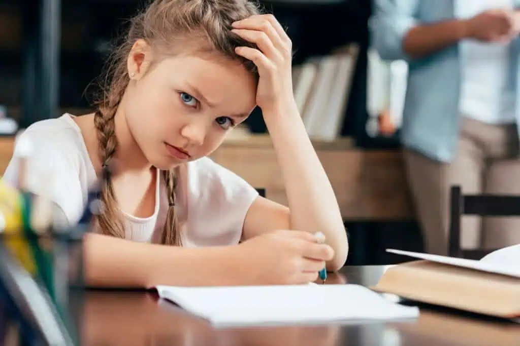 little girl writing homework