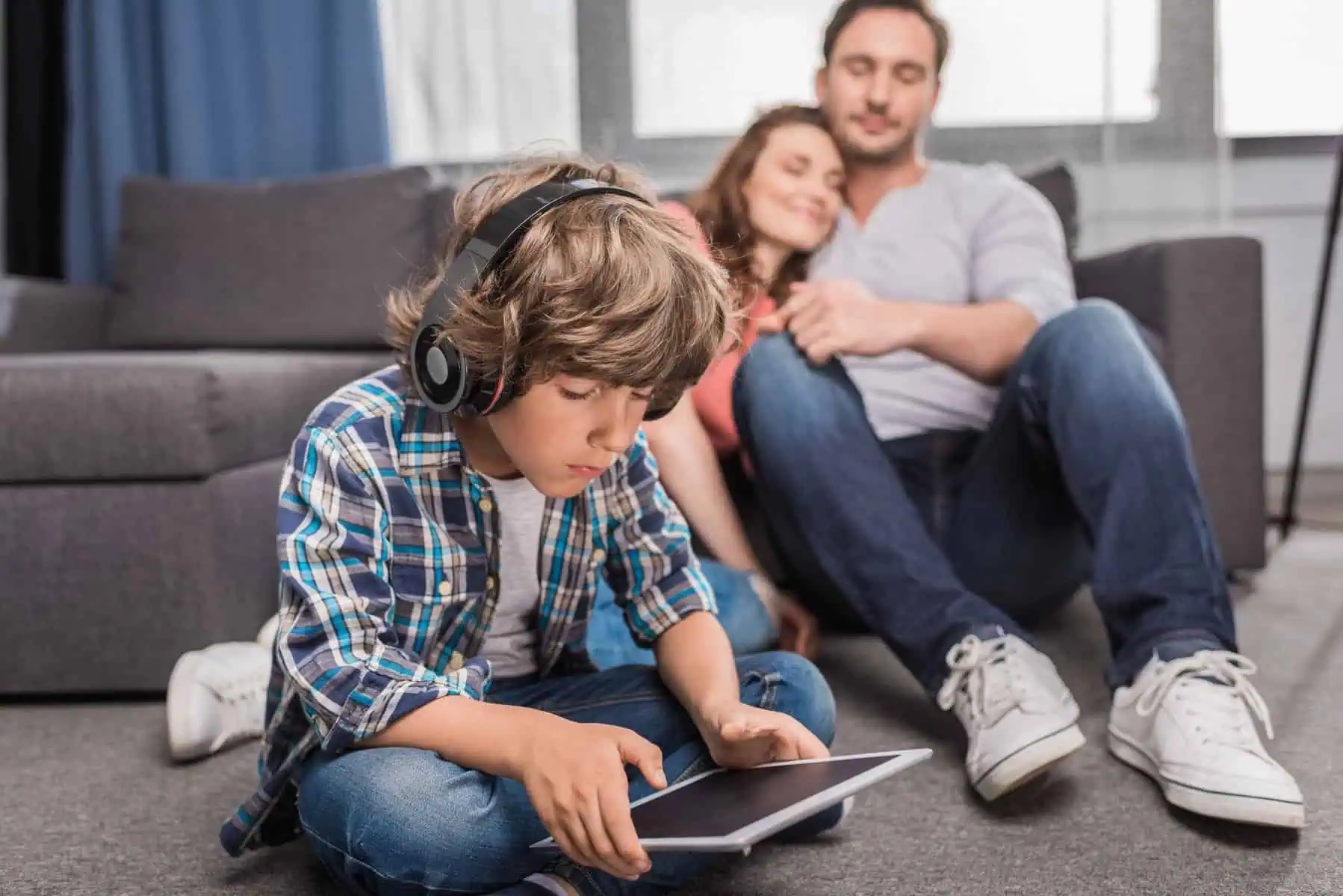 kid in headphones with tablet