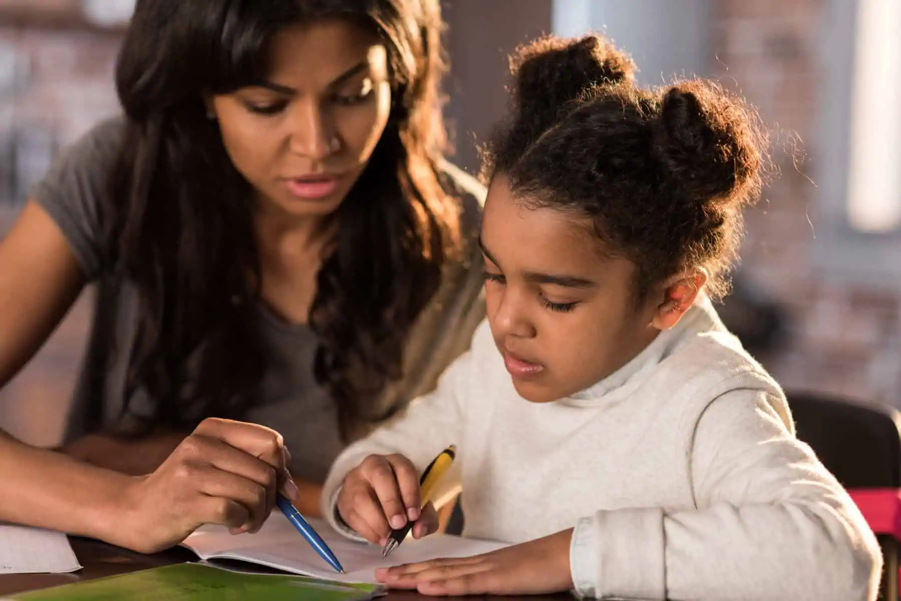 Mother with daughter doing homework