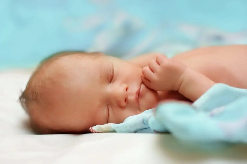 newborn baby on blue blanket