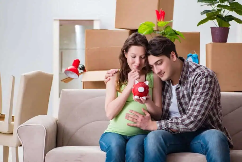 Young couple saving money for baby to be born