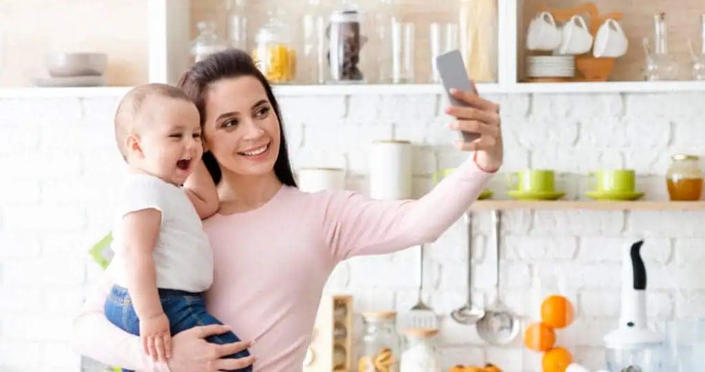 Mom takes selfie with baby in kitchen
