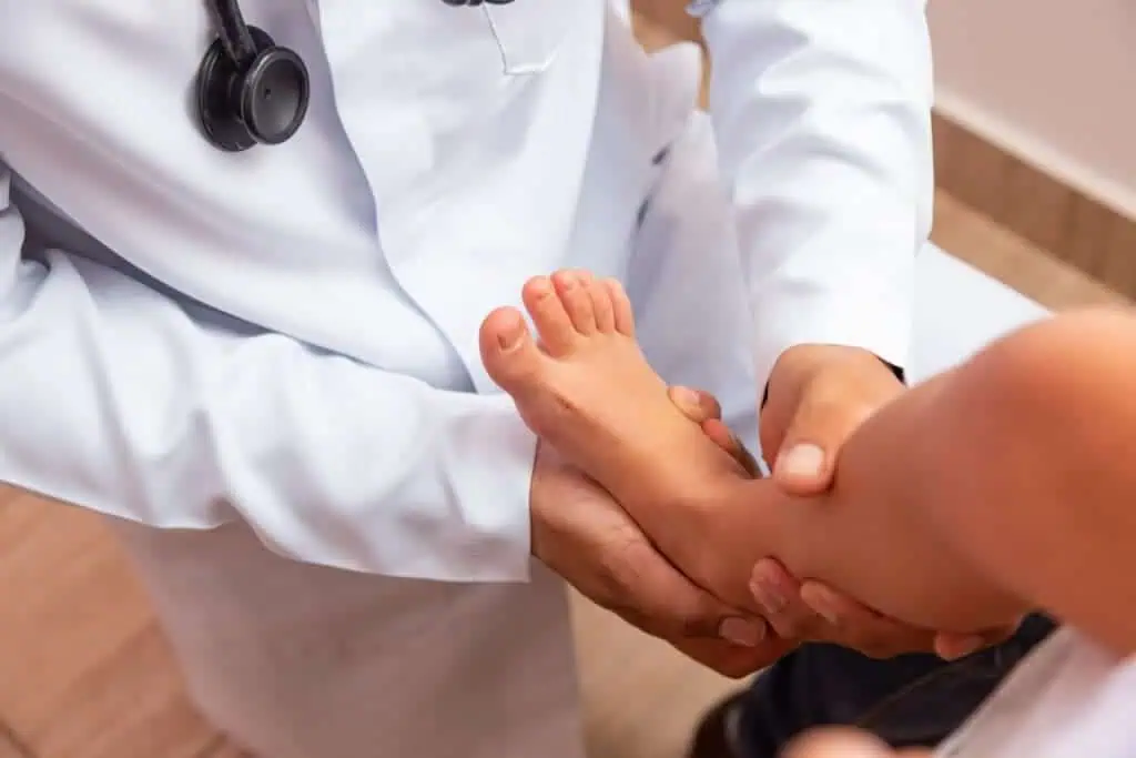 Doctor holds child's foot while examining it