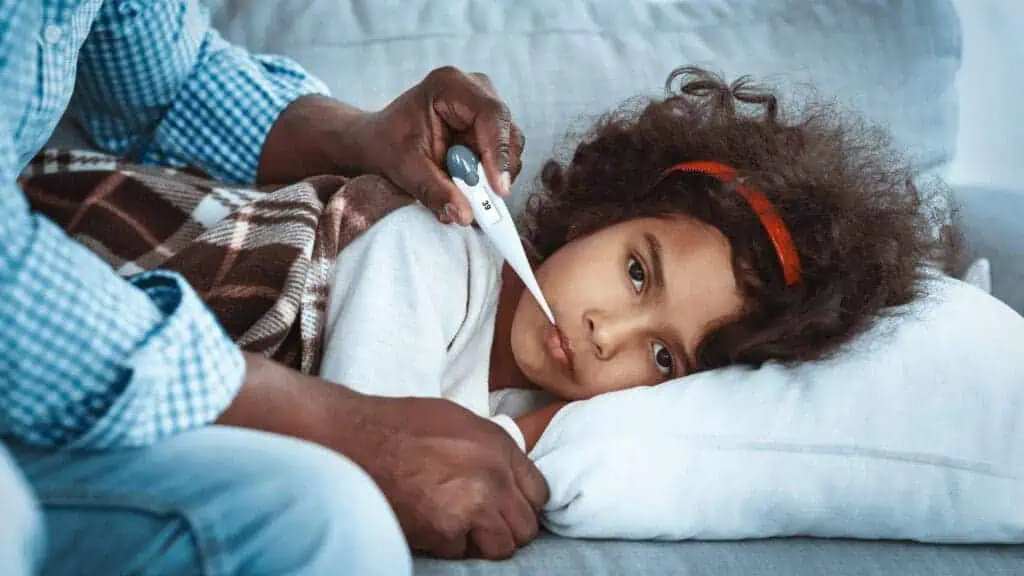 sick child getting temperature taken