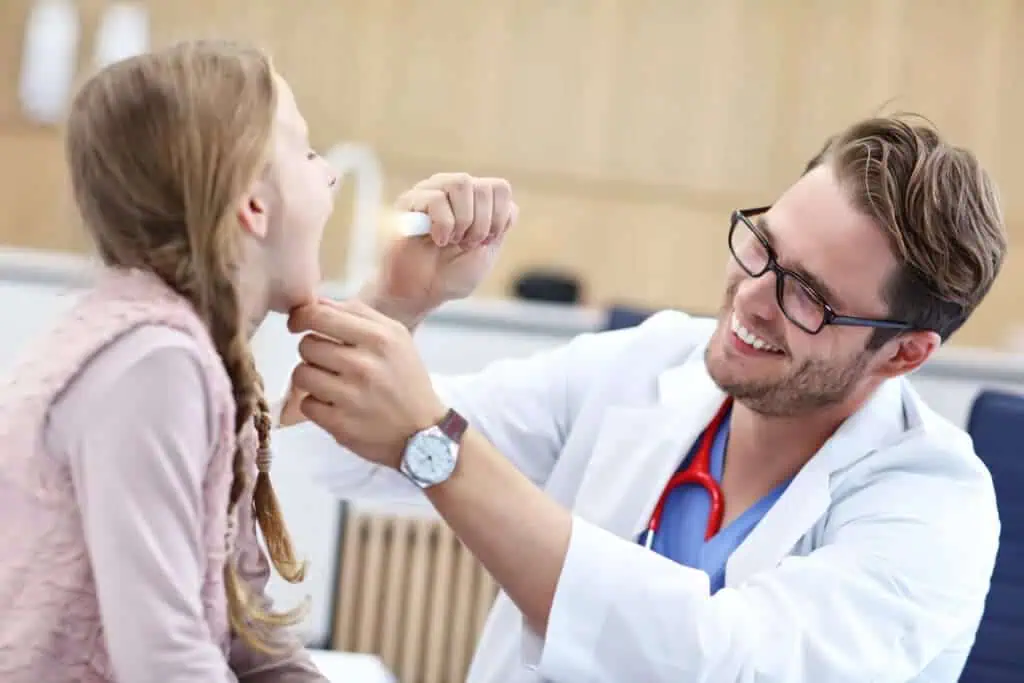 Child getting throat checked at doctor
