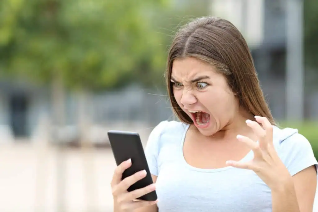 Teen yells in frustration at her smartphone