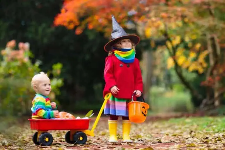 Kids trick or treat on Halloween night.