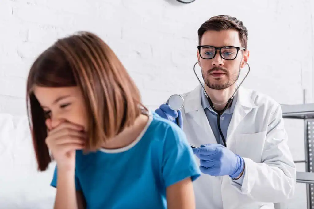 coughing child is examined by doctor