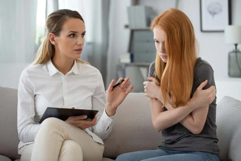 Therapist works through problems with young female patient