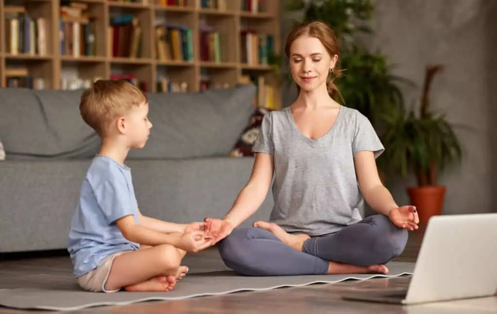 Mom relaxes with yoga while helping her son
