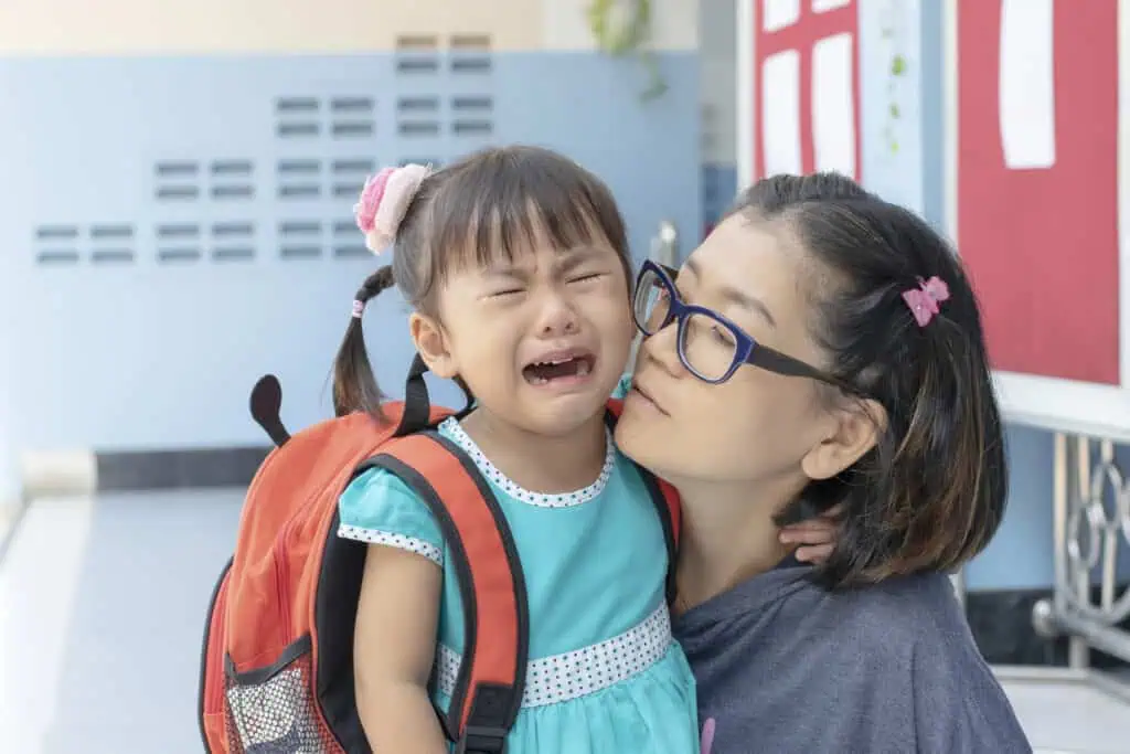Child cries at school as mother attempts to comfort