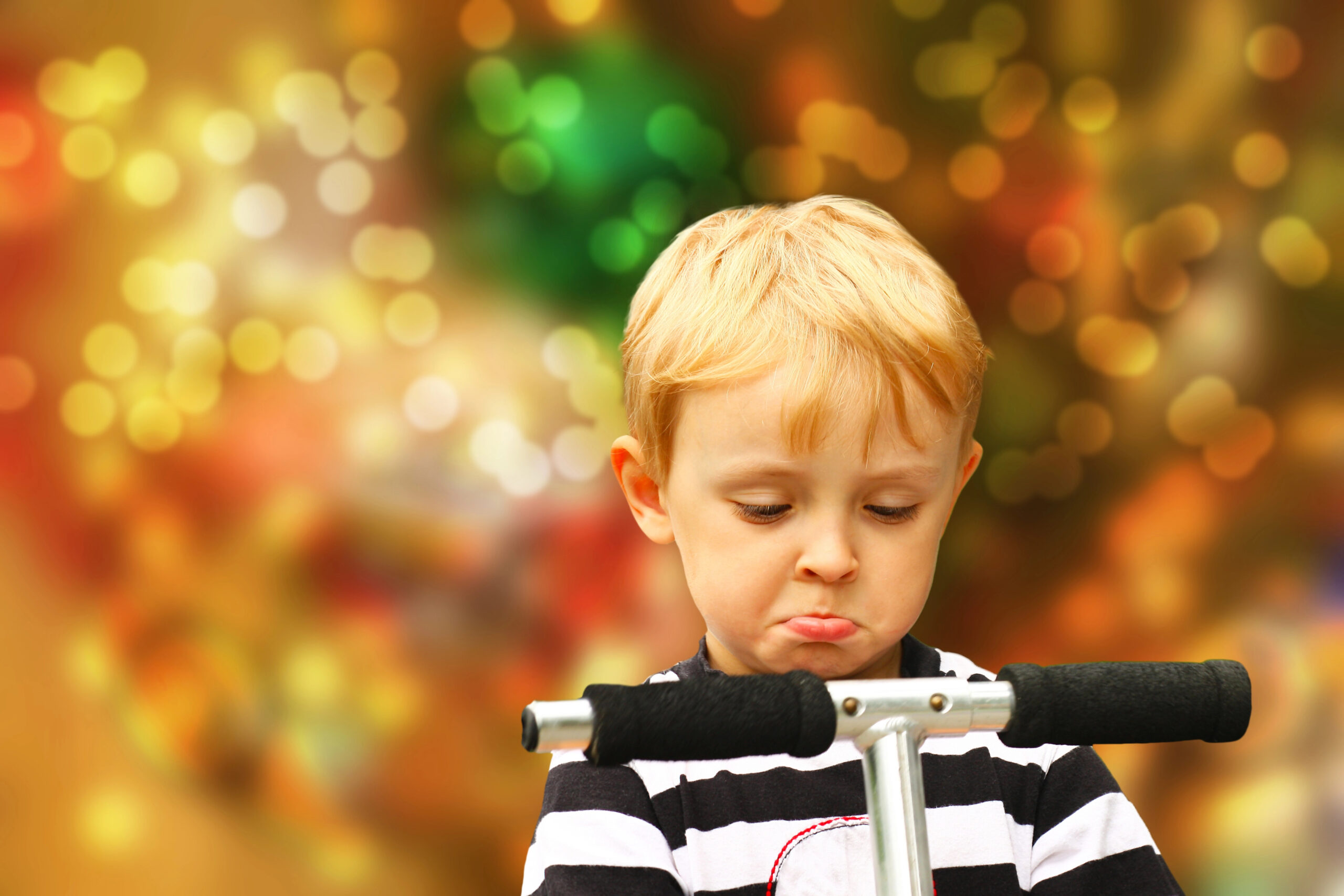 Child tries out scooter in front of Christmas 