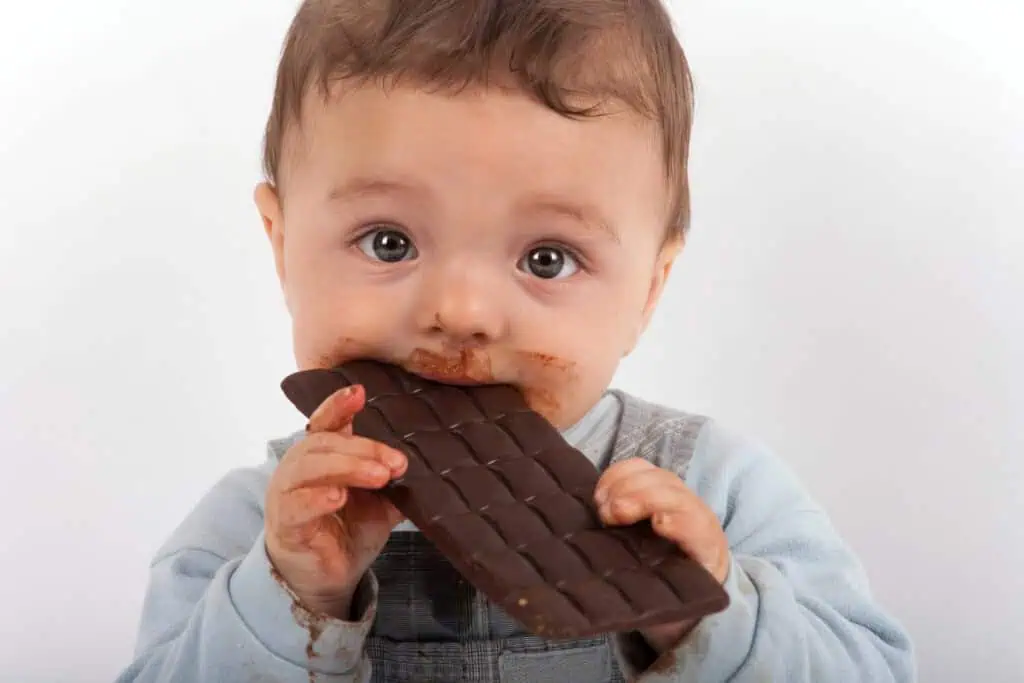 baby eating chocolate bar