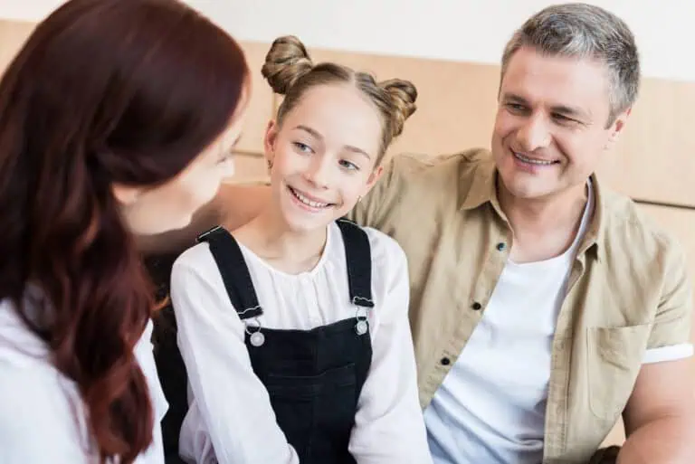 Parents spending time with smiling teen girl