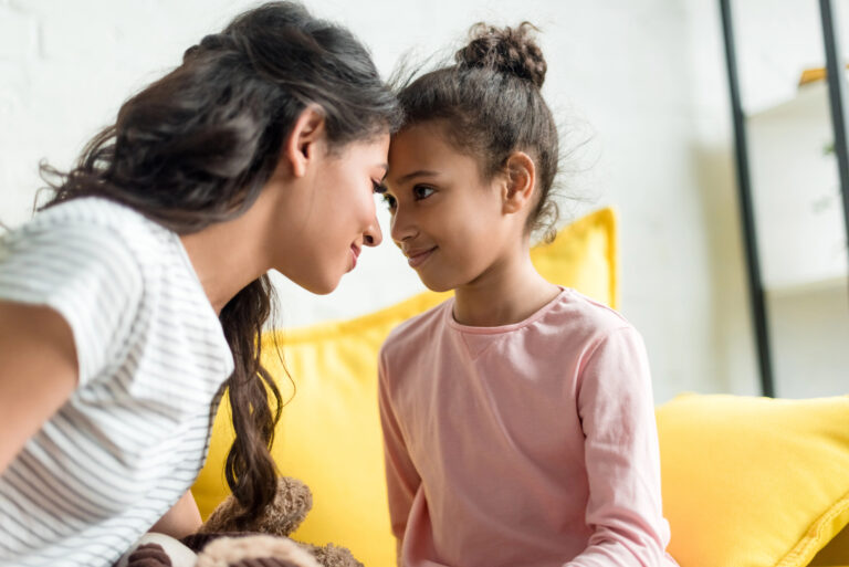 Mother and daughter connect on sofa