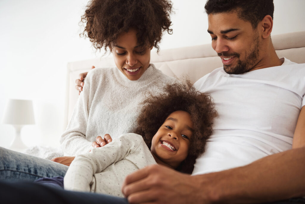 Child Smiling With Family