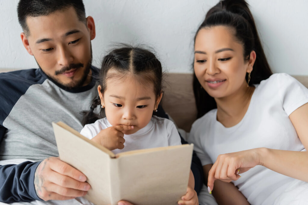 Parents enjoy book with small daughter