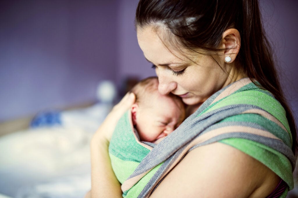 Newborn baby hold by mother