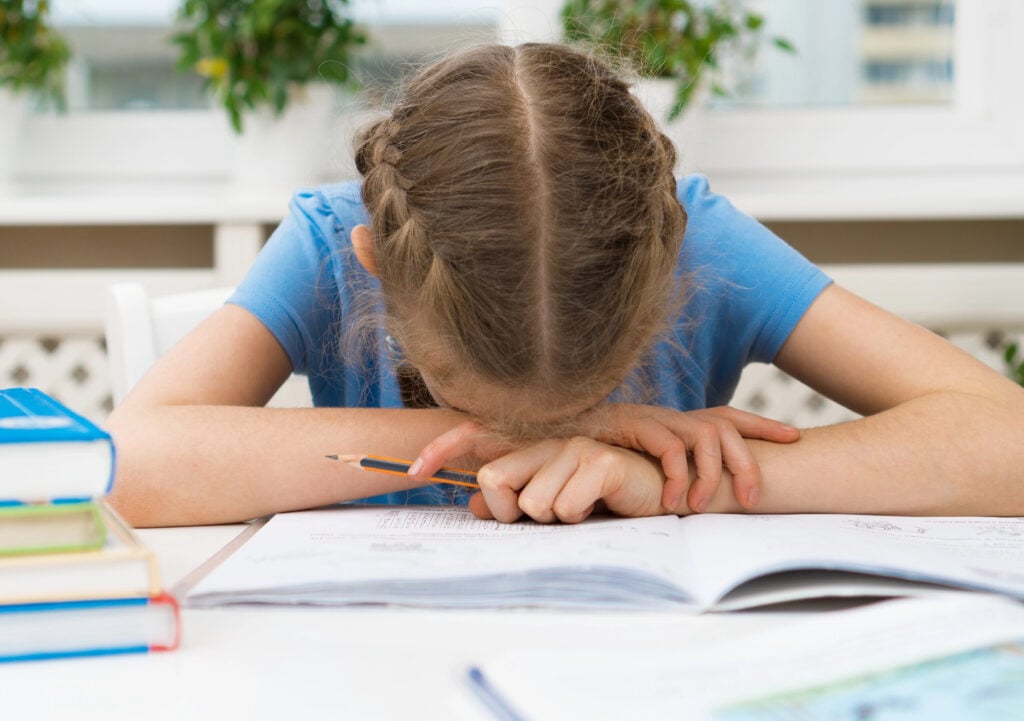 Little girl don't want to do her homework.