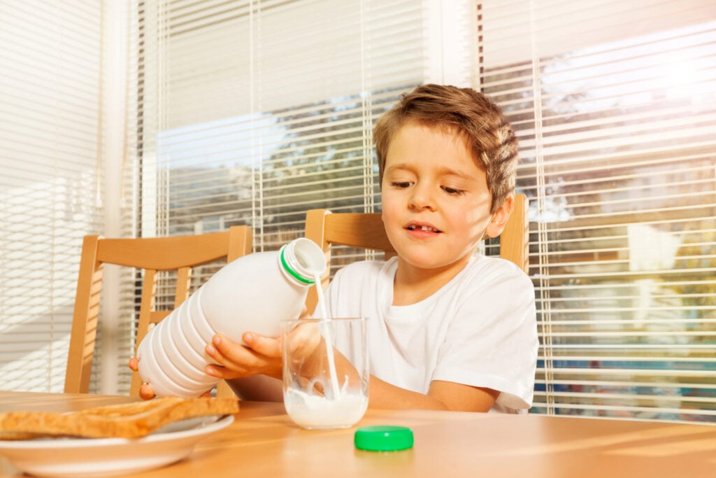 A child is pouring milk