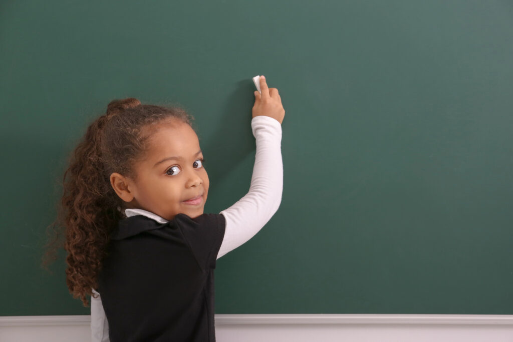 Child teaches with chalkboard