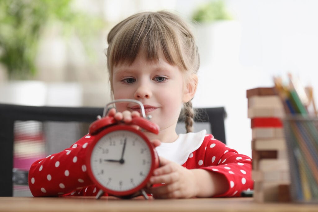 Child learning to set a clock