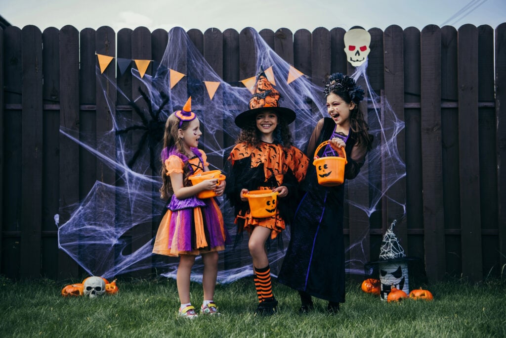 Kids comparing candy during trick-or-treat outing