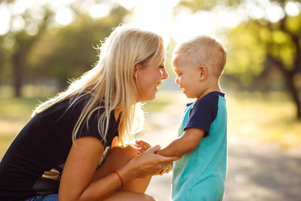 Mom talks to small boy in park