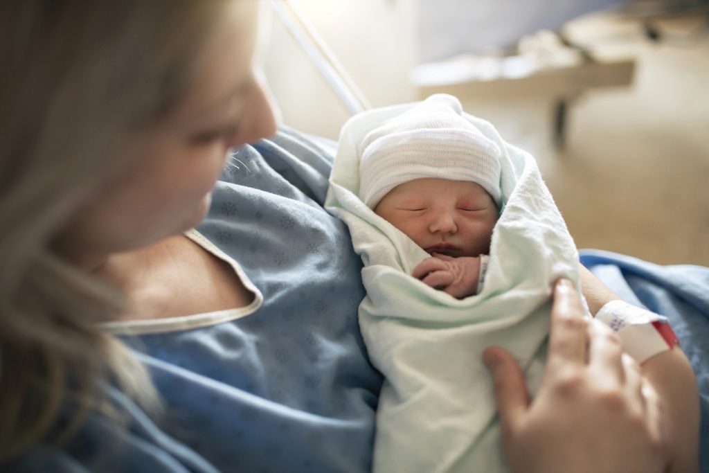 Mother with her newborn baby at the hospital a day after a natural birth labor