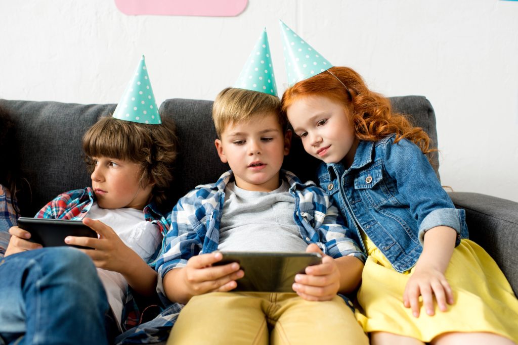 kids using gadgets at birthday party