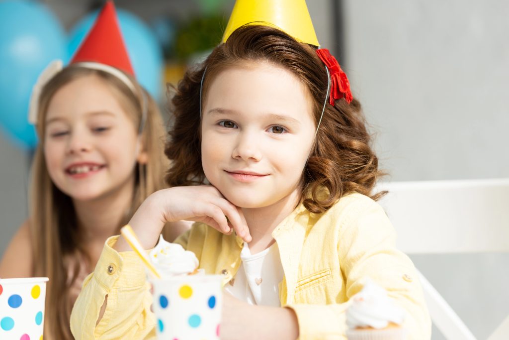 adorable kids in party caps during birthday celebration