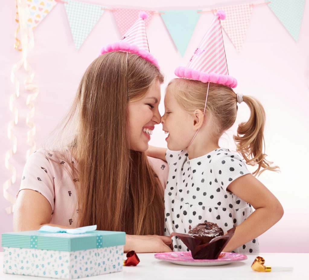 Birthday girl and mom in caps