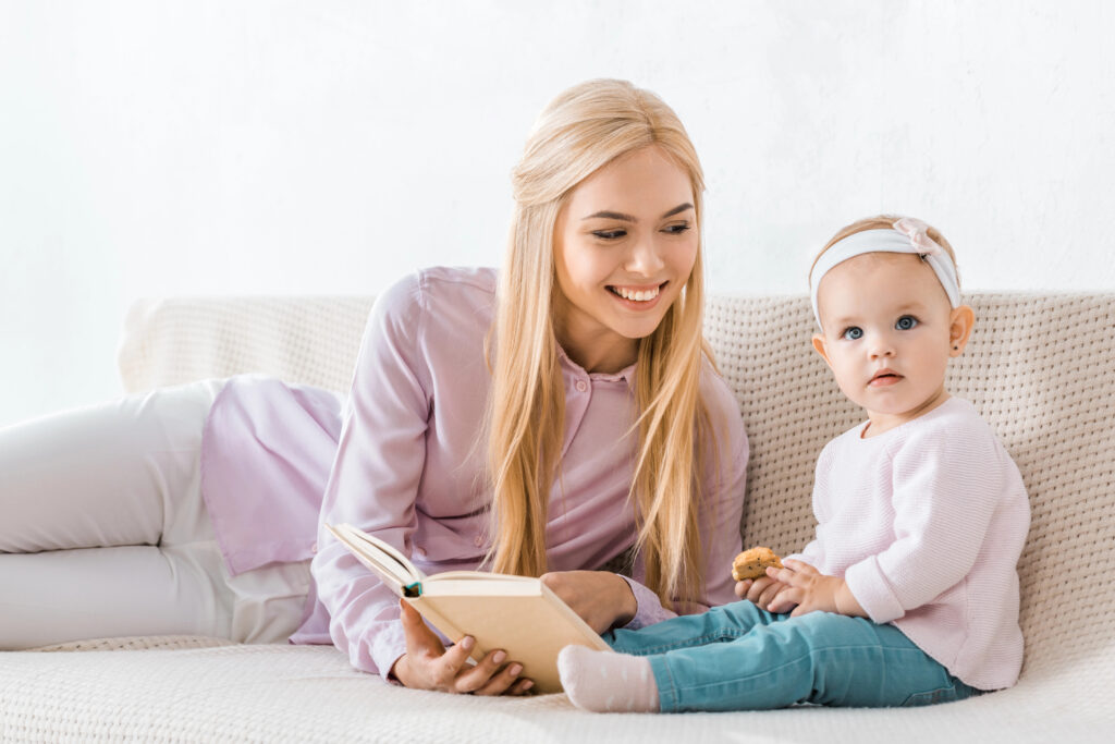 Toddler and mom enjoy book and cookie