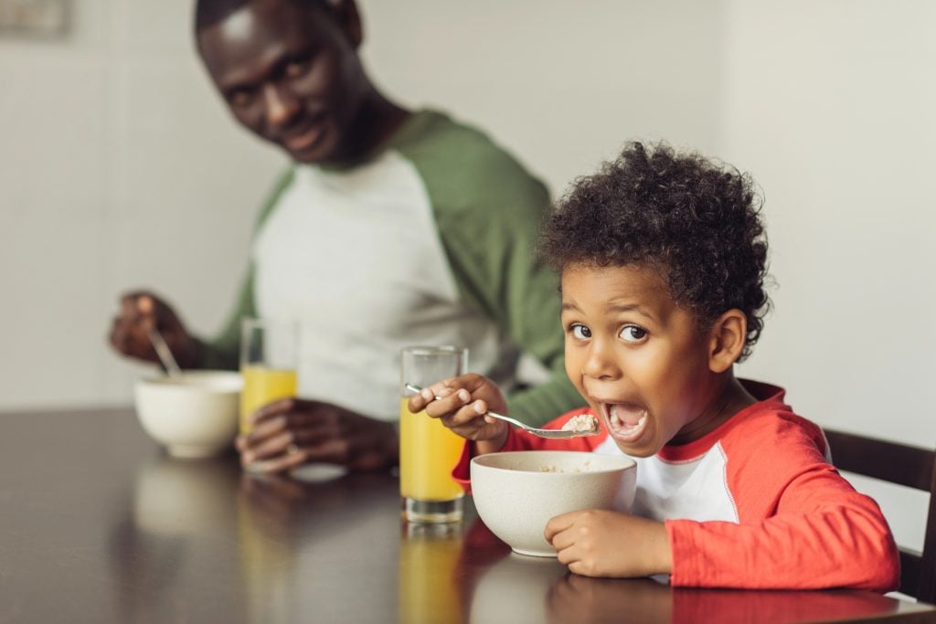 father and son eating breakfast