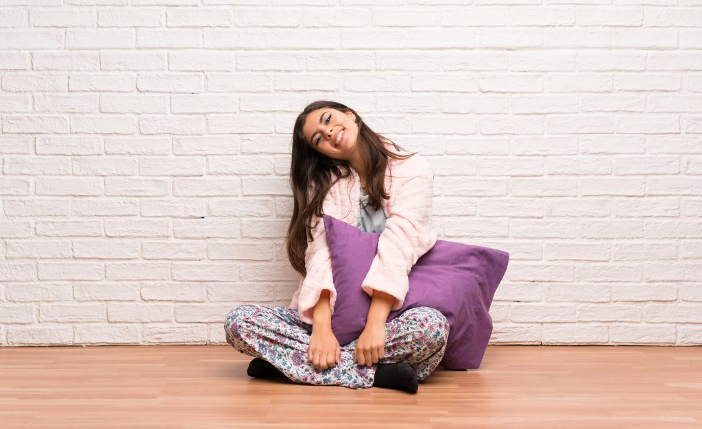 Teenager girl in pajamas smiling