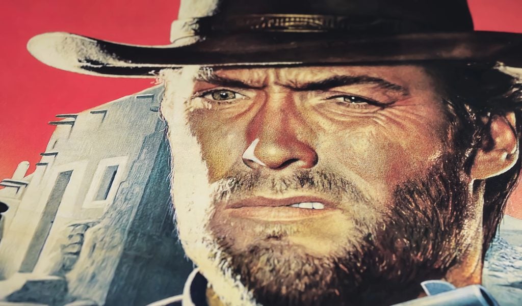 Viersen, Germany - May 9. 2024: Detail of official For a Few Dollars More cinema film poster with Clint Eastwood from 1965 (focus on center)