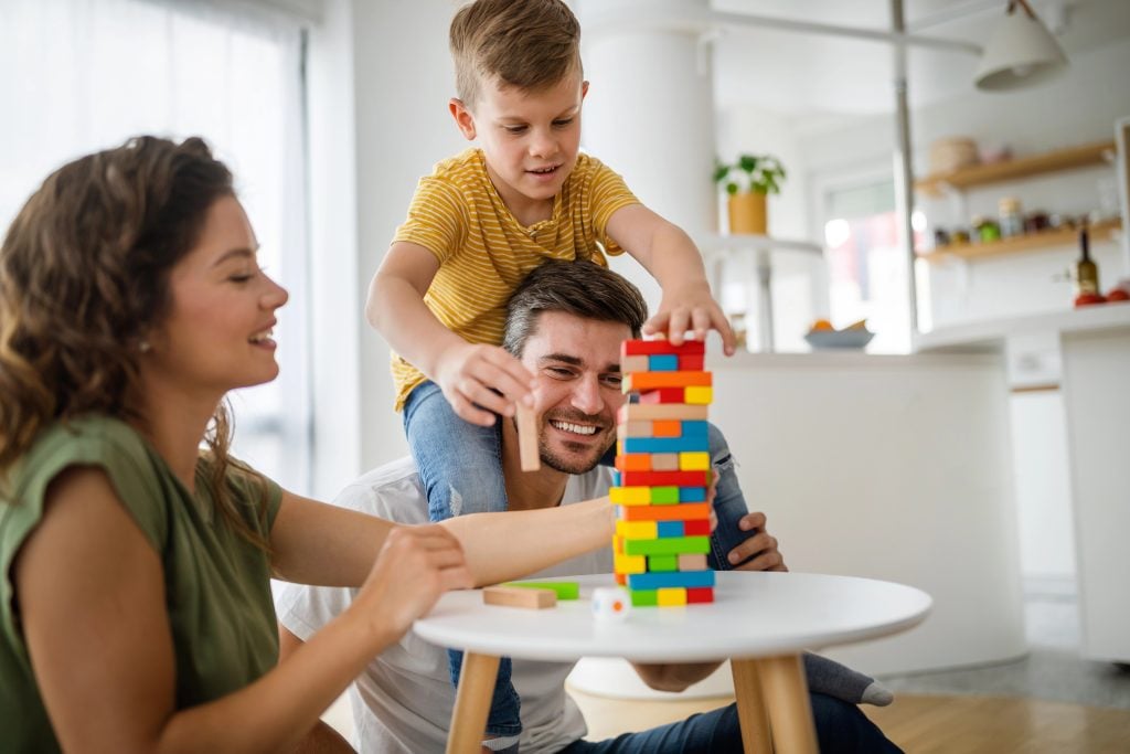 Happy young family having fun, playing together at home