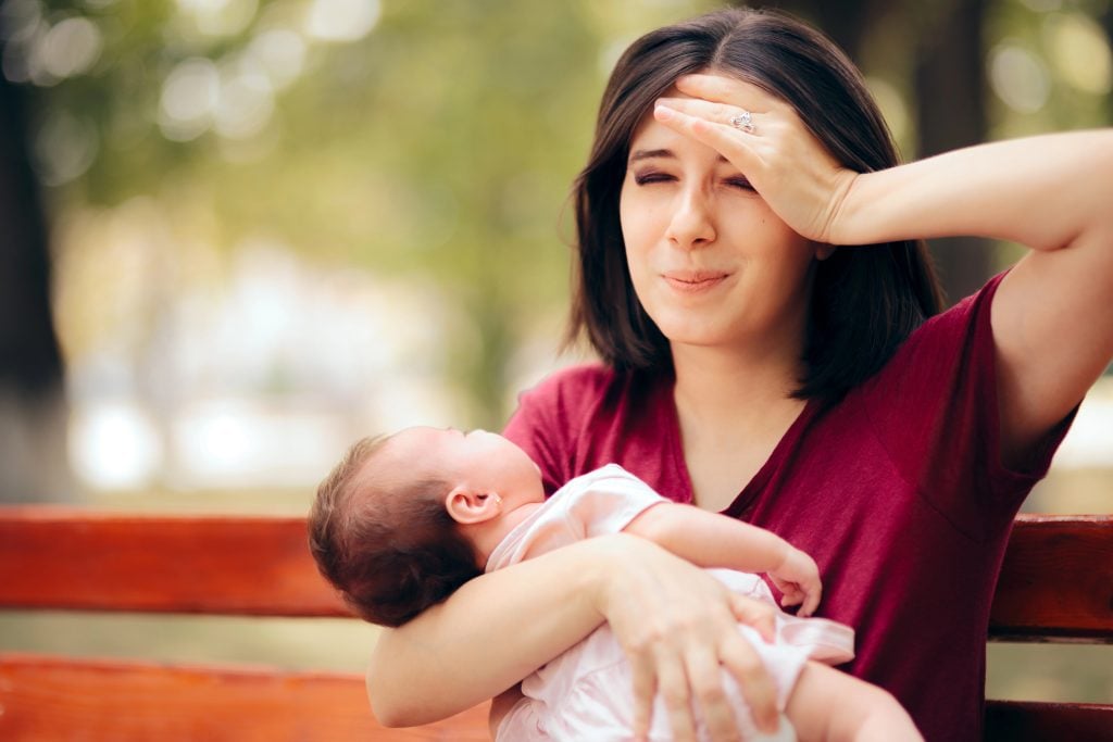 Stressed Anxious Mother Holding Newborn Daughter