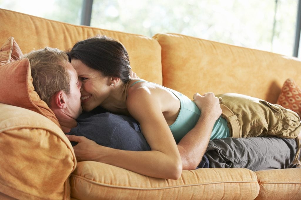 Romantic Couple Lying On Sofa
