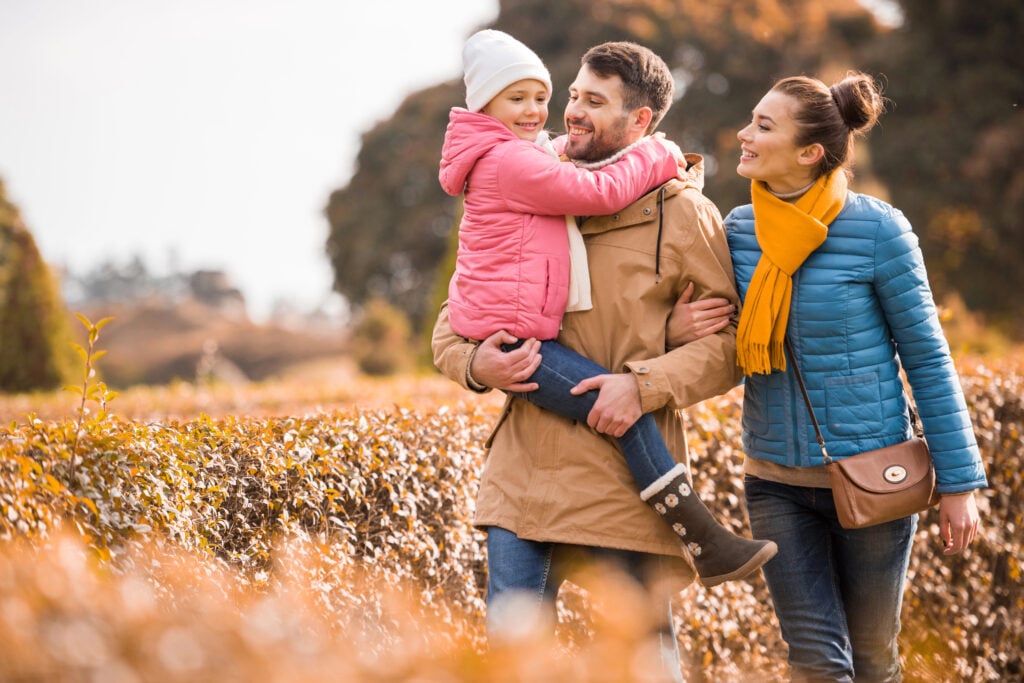 Happy family walking in park