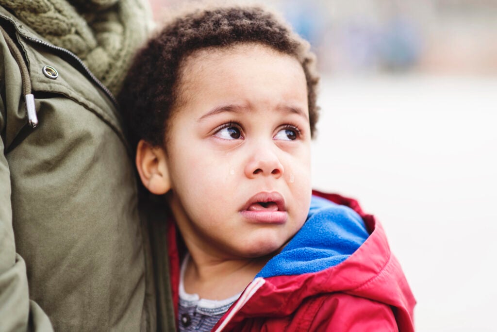 Portrait of a little upset toddler boy crying.