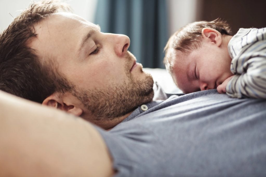Father and Baby having wonderful time on bed on the morning