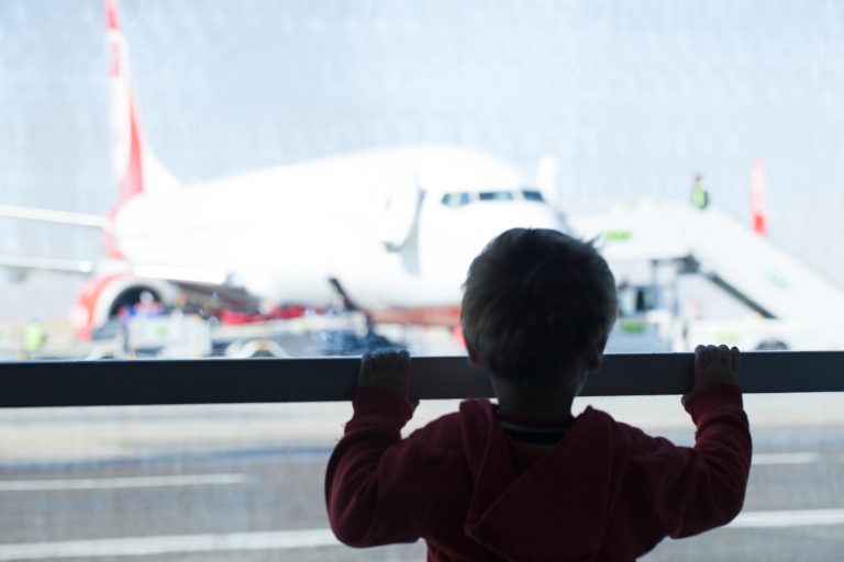 Little boy watching planes at the airport