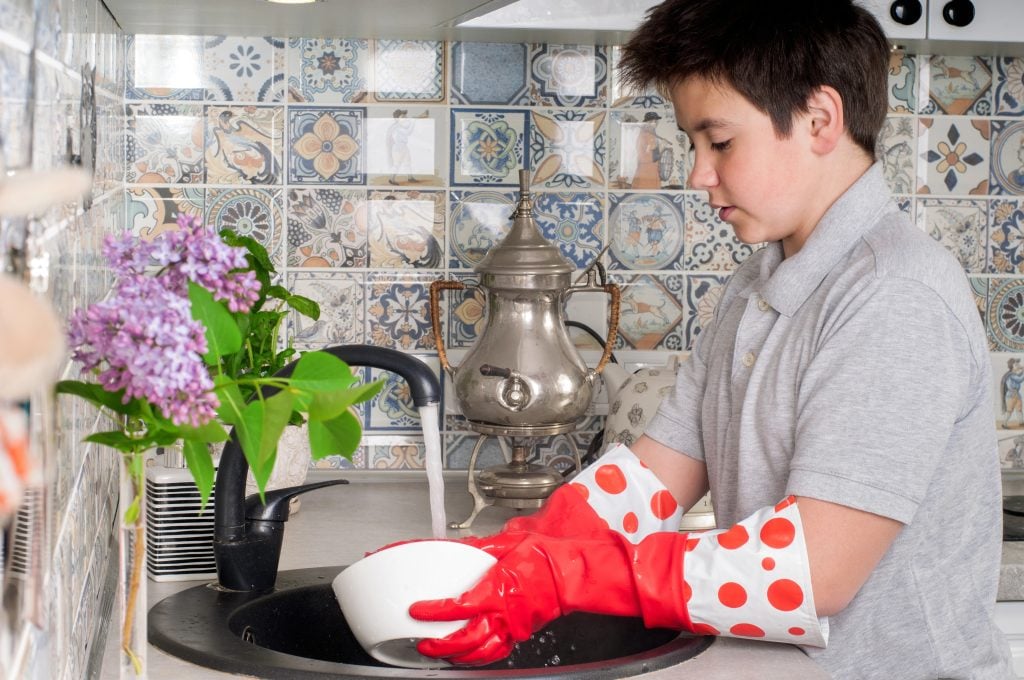 Boy washing dishes